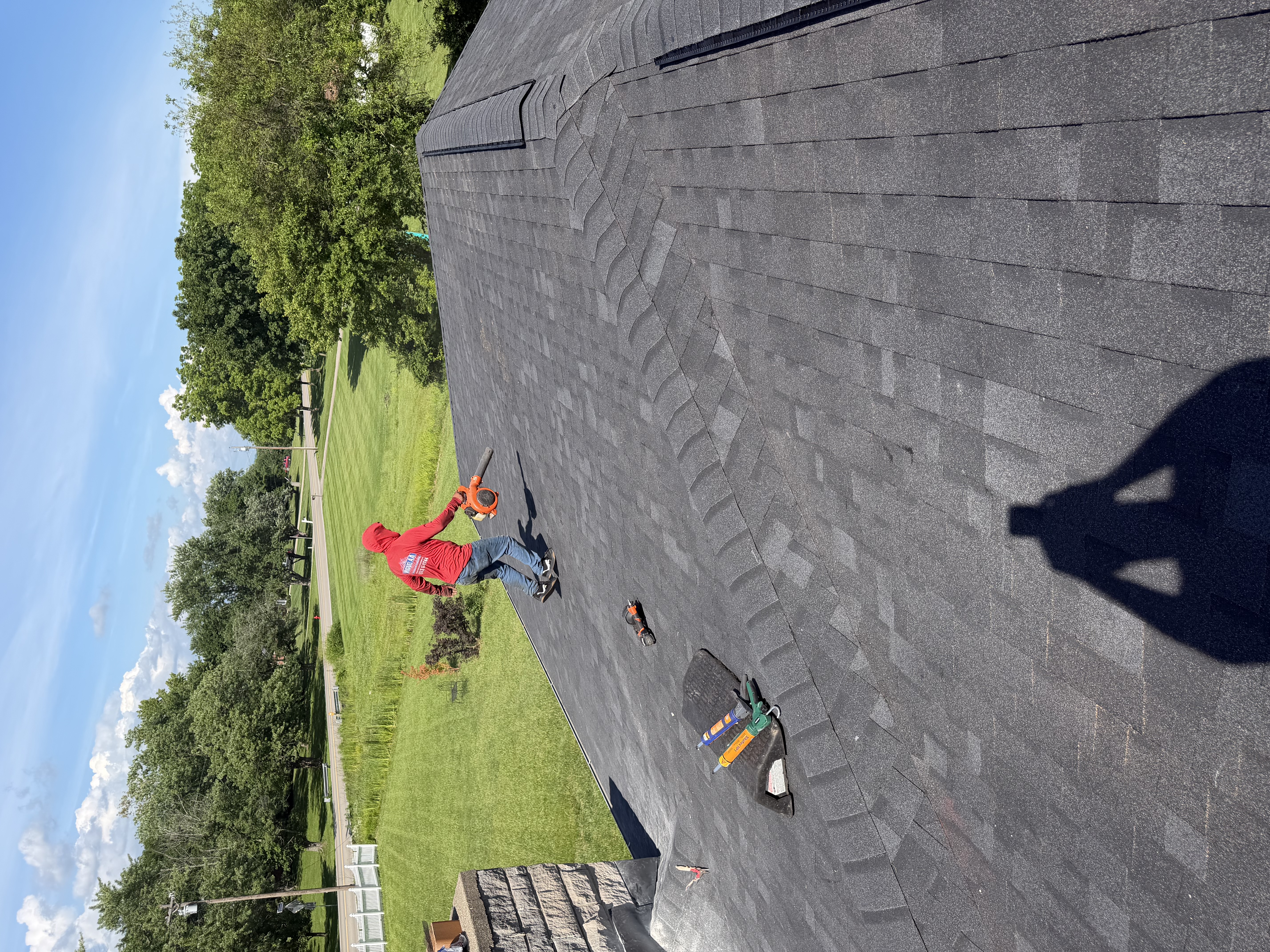 Roofer documenting roof conditions during an insurance claim inspection